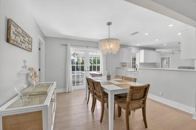a view of a dining room with furniture wooden floor and chandelier