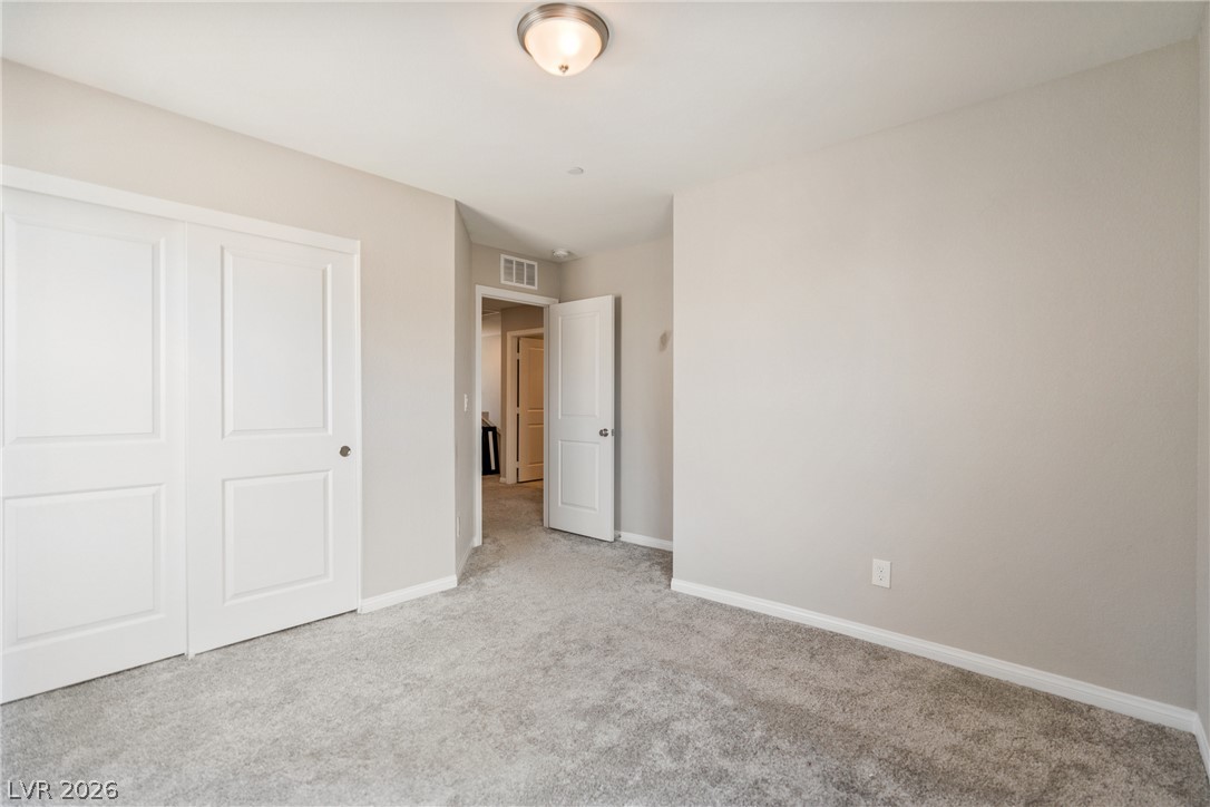 2495 Rofrano Place Henderson, NV 89044 - Photo 12 of 20 Plush wall-to-wall carpeting and clean trim-work define this versatile bedroom space.