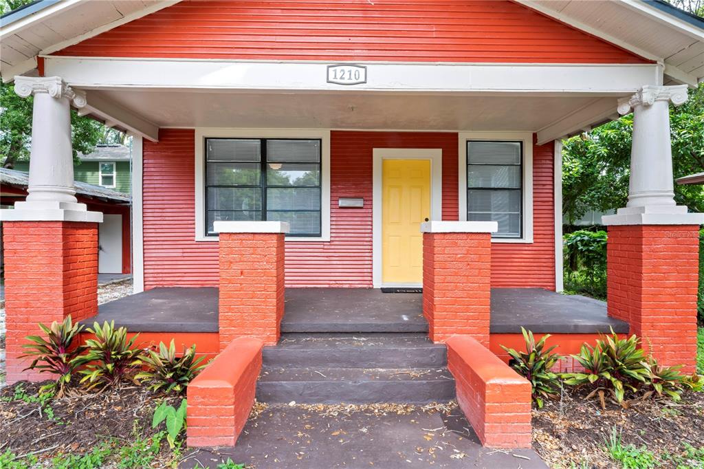 1210 East 24th Avenue Tampa, FL 33605 - Photo 1 of 16 a front view of a house with large windows