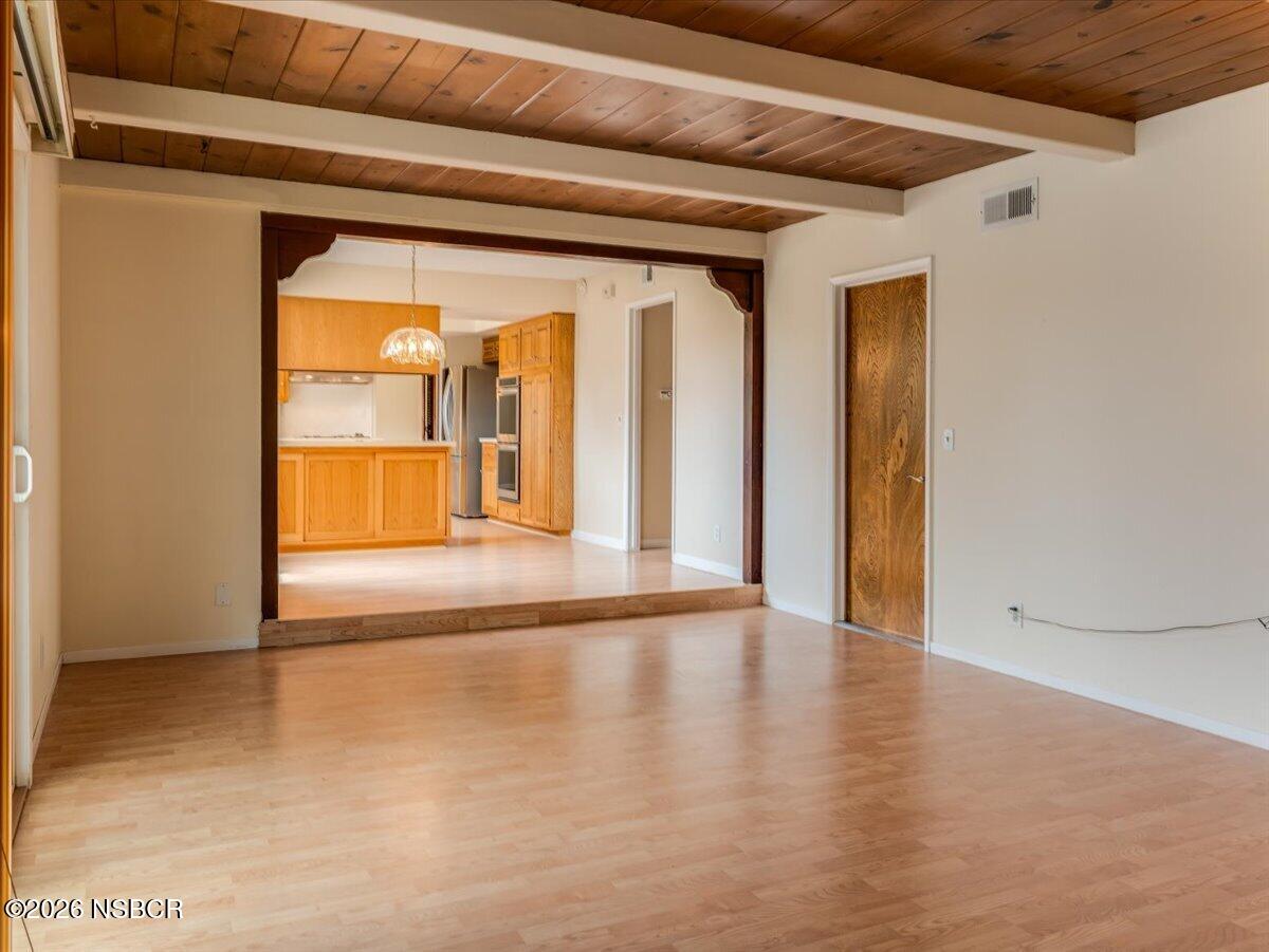 360 Tallyho Road Santa Maria, CA 93455 - Photo 29 of 72 a view of an empty room with wooden floor and a window