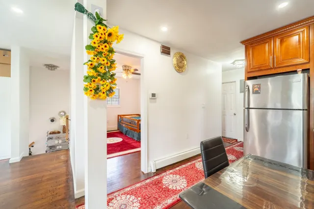 a living room with a couch and a potted plant