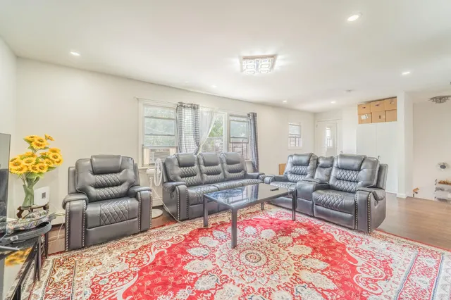 a living room with furniture rug and window