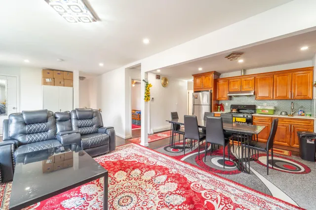 a living room with furniture a rug and a large window