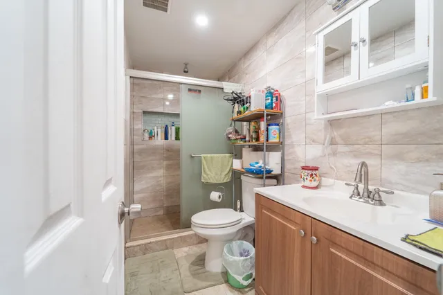 a bathroom with a sink a toilet and shower curtain