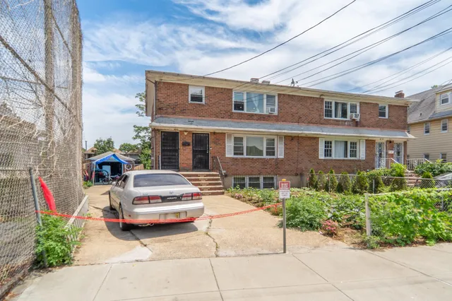 a car parked in front of a brick building