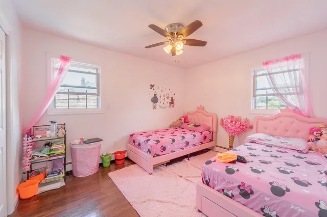 a bedroom with baby bed and a window