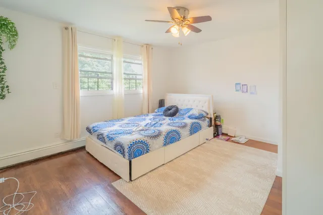 a bedroom with a bed rug and window