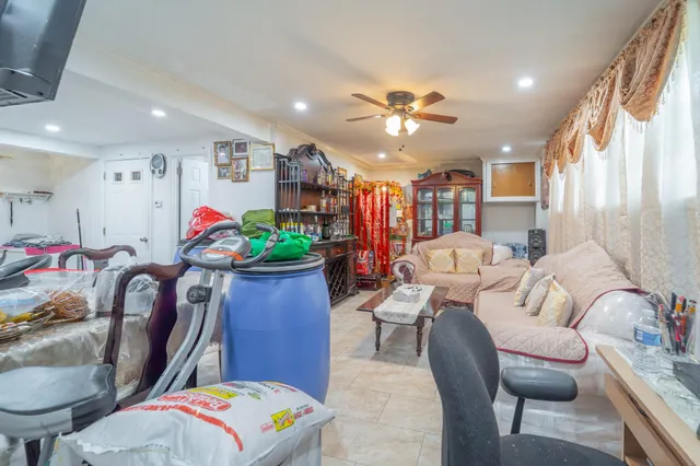 a living room with furniture flowerpot and window