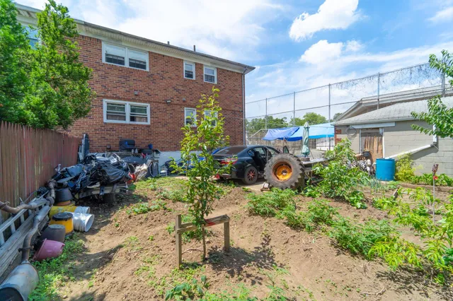 a front view of a house with a yard and sitting area