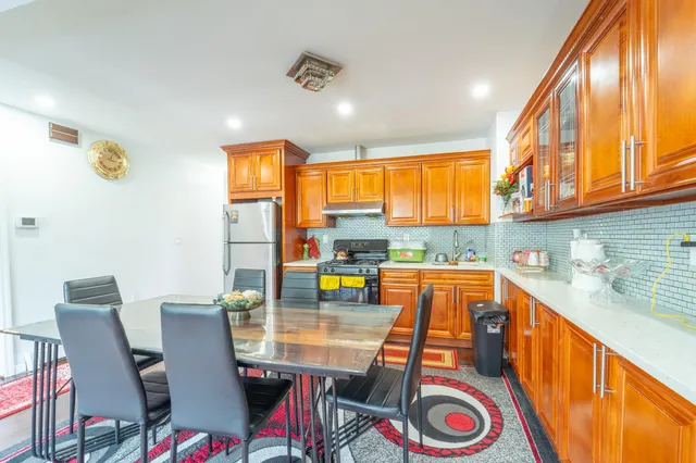 a dining room with furniture a rug and wooden floor