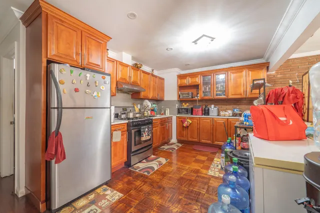 a kitchen with stainless steel appliances granite countertop a refrigerator and a stove top oven
