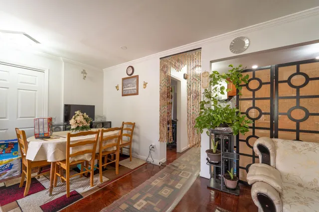 a dining room with furniture and wooden floor