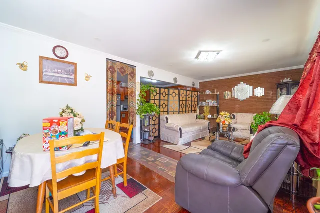 a living room with furniture chess board and a couch