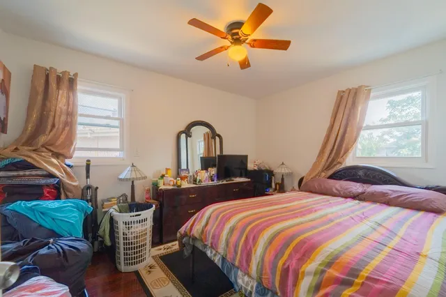 a bedroom with bed and a window