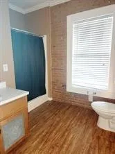 a bathroom with a sink a toilet and a window