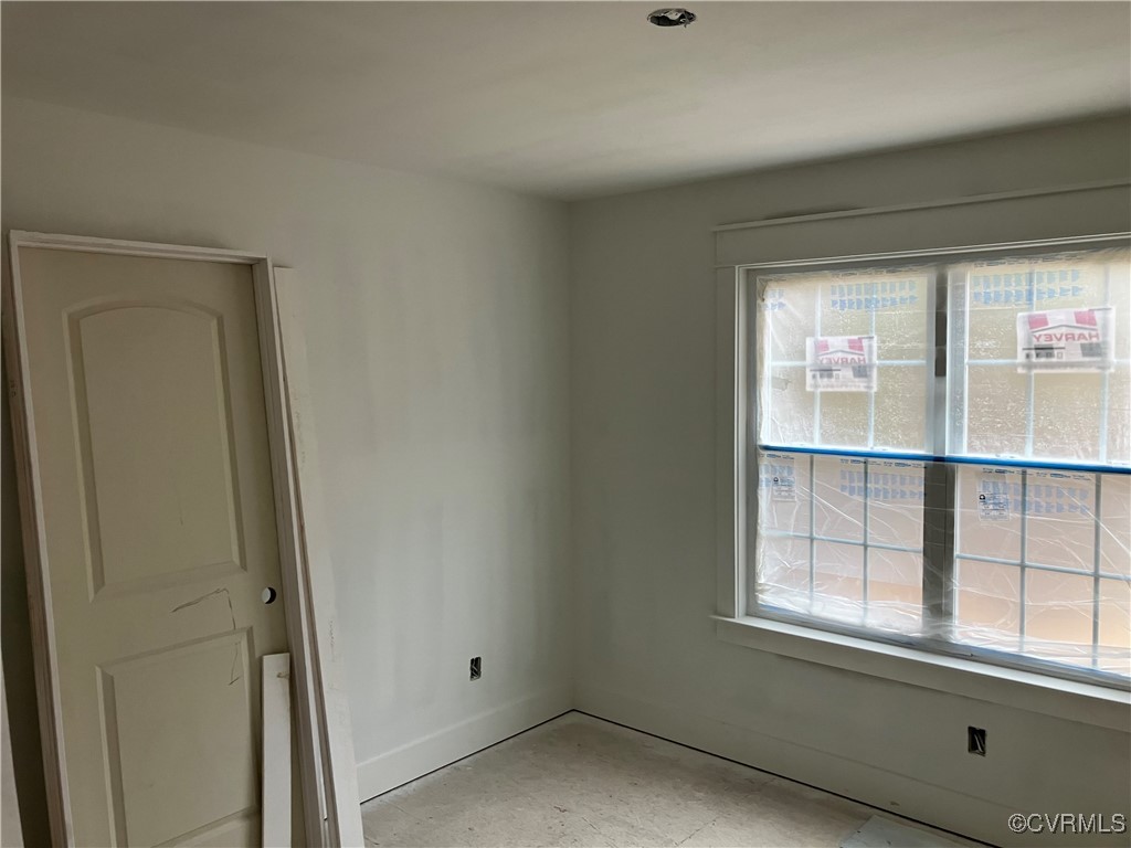 Unfurnished room featuring plenty of natural light