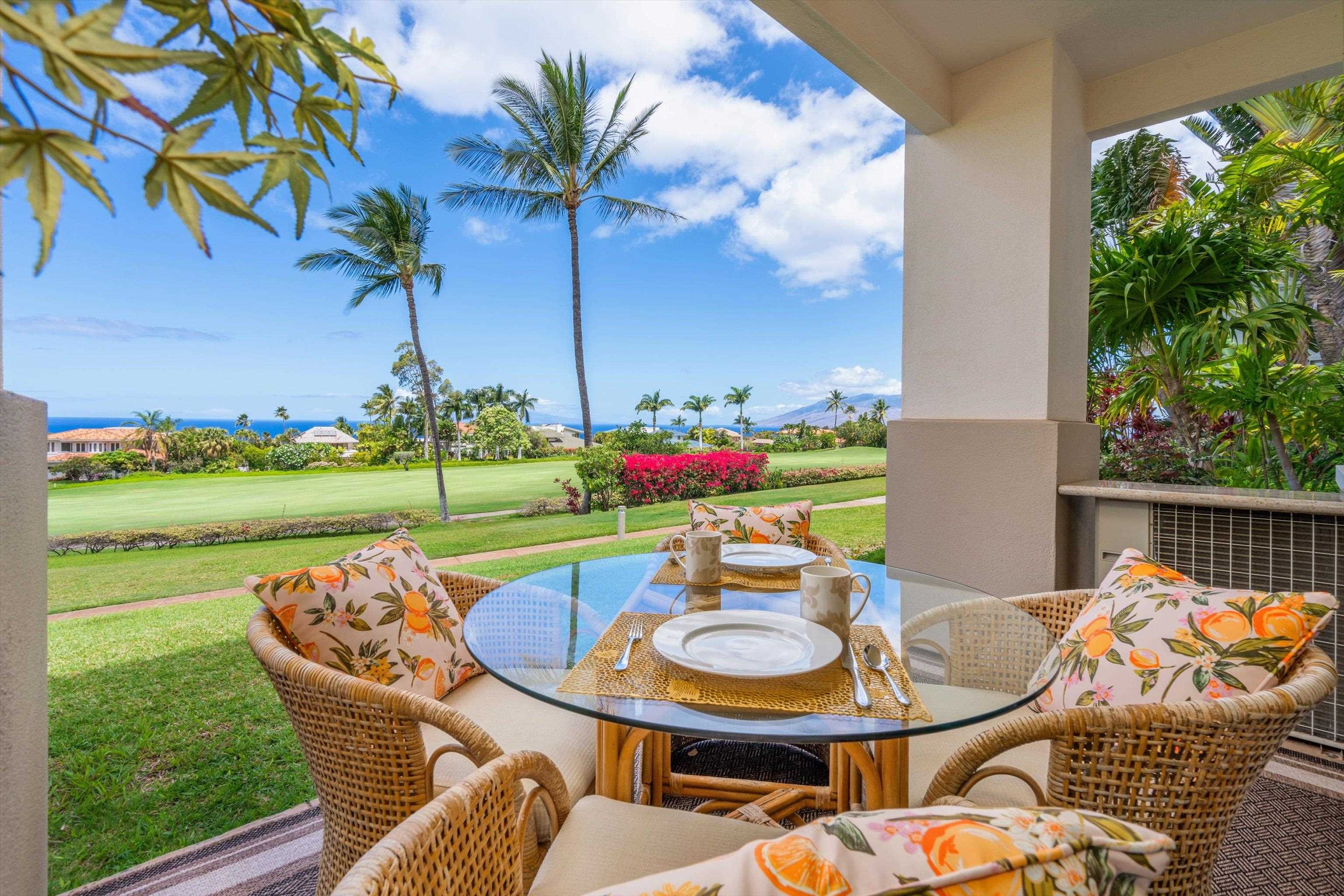 3950 Kalai Waa Street, Unit R 103 Kihei, HI 96753 - Photo 11 of 50 a view of a chairs and table in patio next to a yard