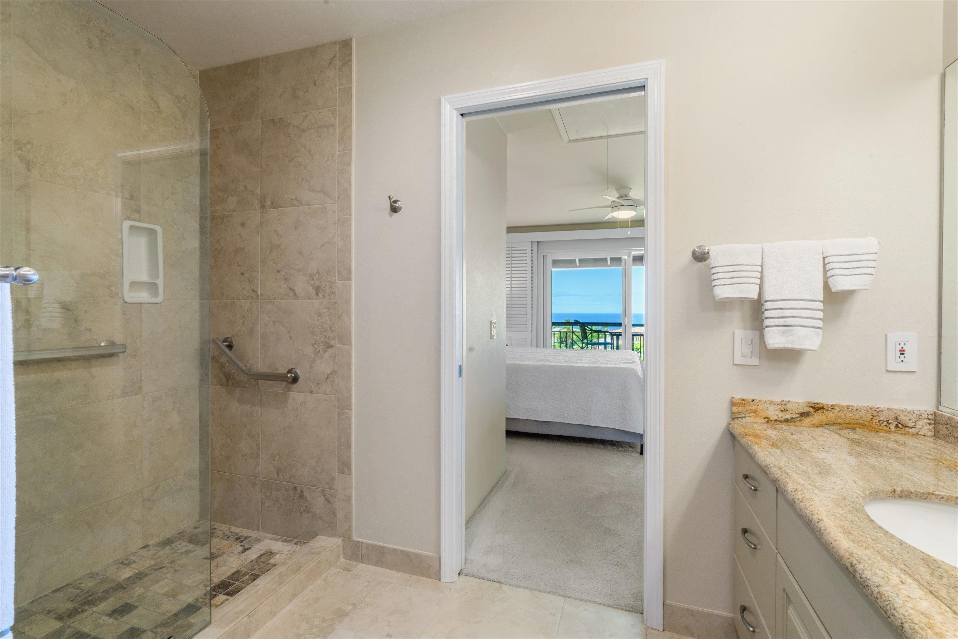 3950 Kalai Waa Street, Unit R 103 Kihei, HI 96753 - Photo 18 of 50 a en suite bathroom with a granite countertop sink and a mirror