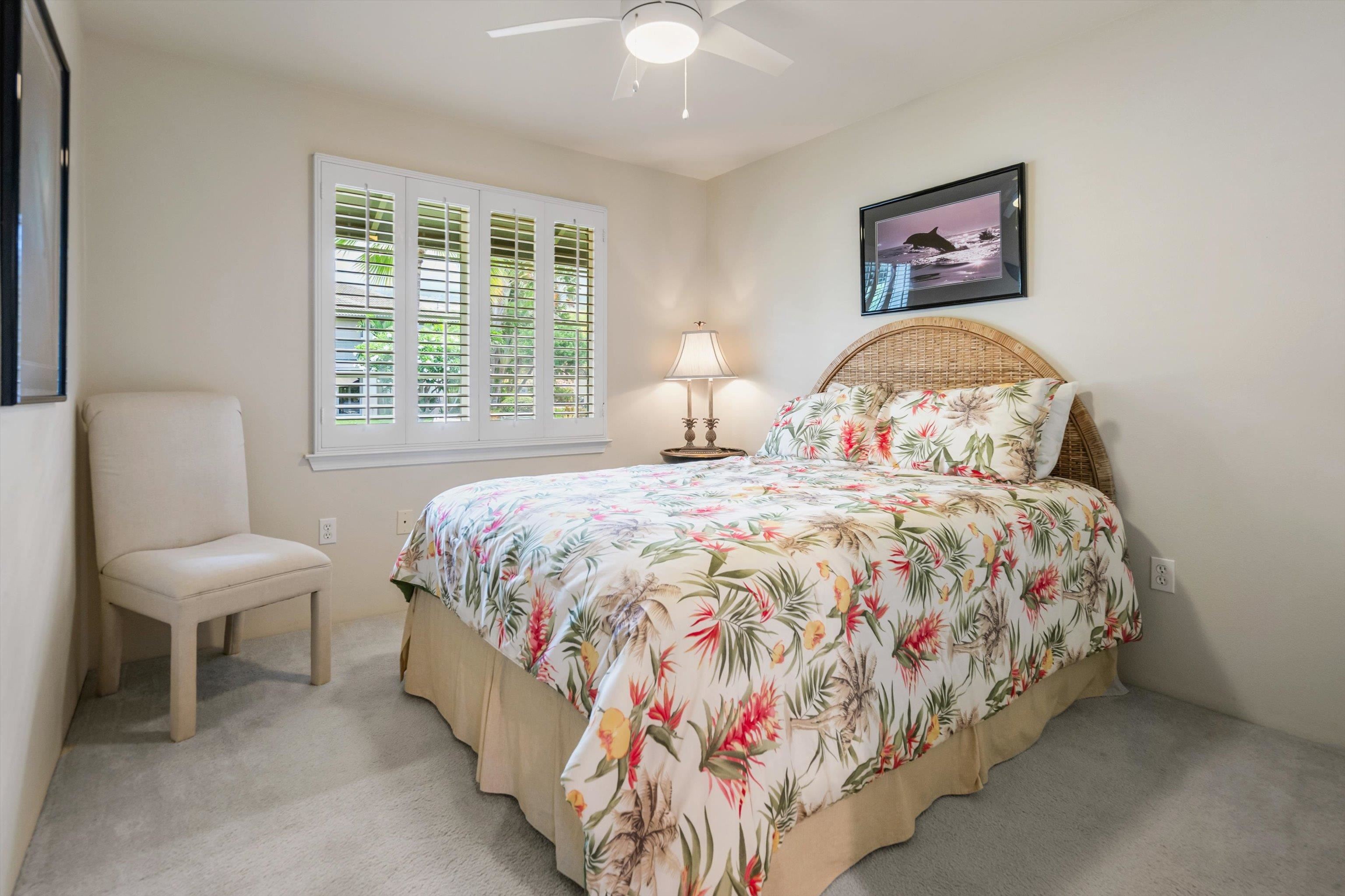 3950 Kalai Waa Street, Unit R 103 Kihei, HI 96753 - Photo 19 of 50 a bedroom with a bed and a painting on the wall