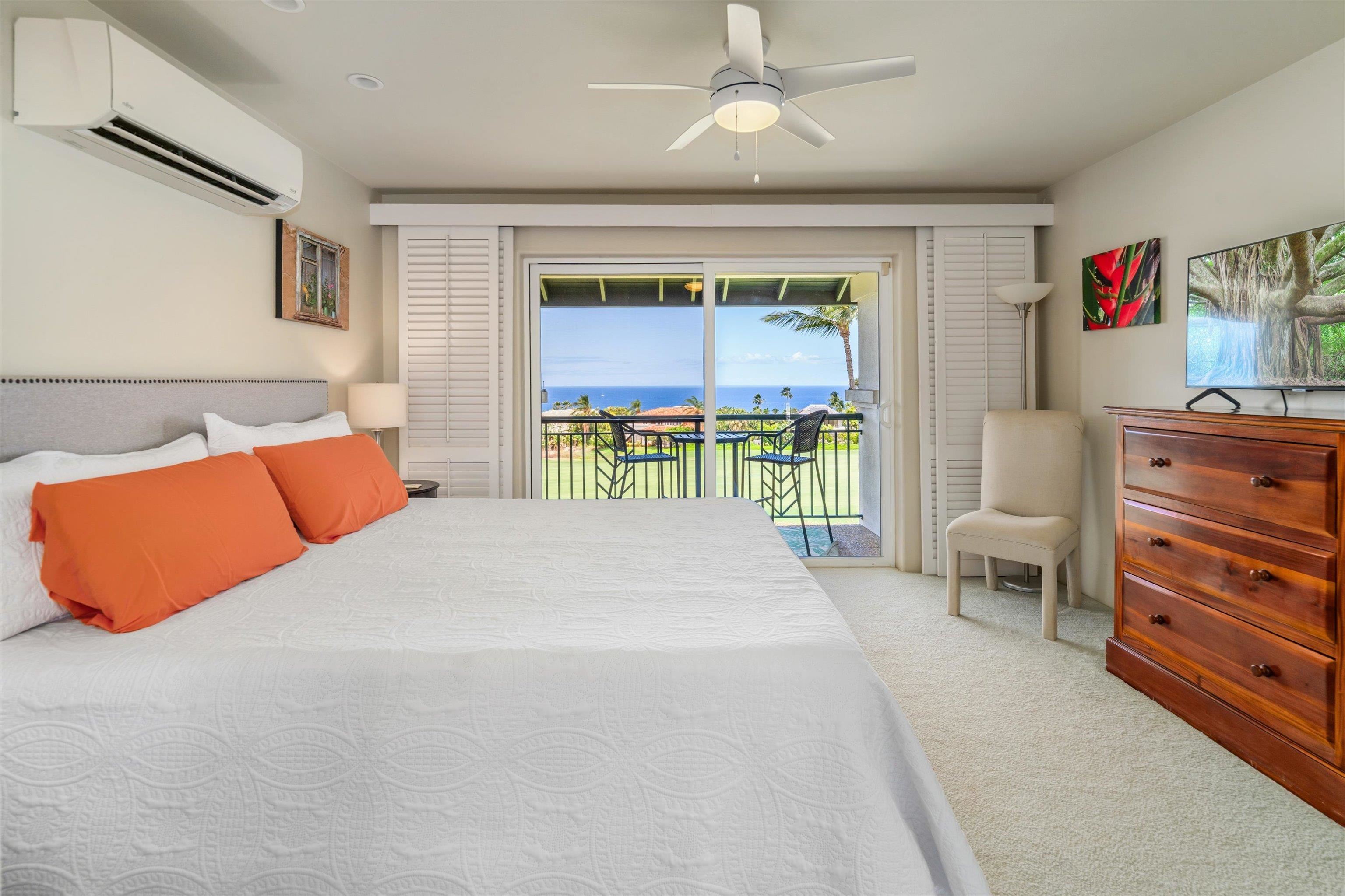 3950 Kalai Waa Street, Unit R 103 Kihei, HI 96753 - Photo 23 of 50 a bedroom with a bed and a chandelier