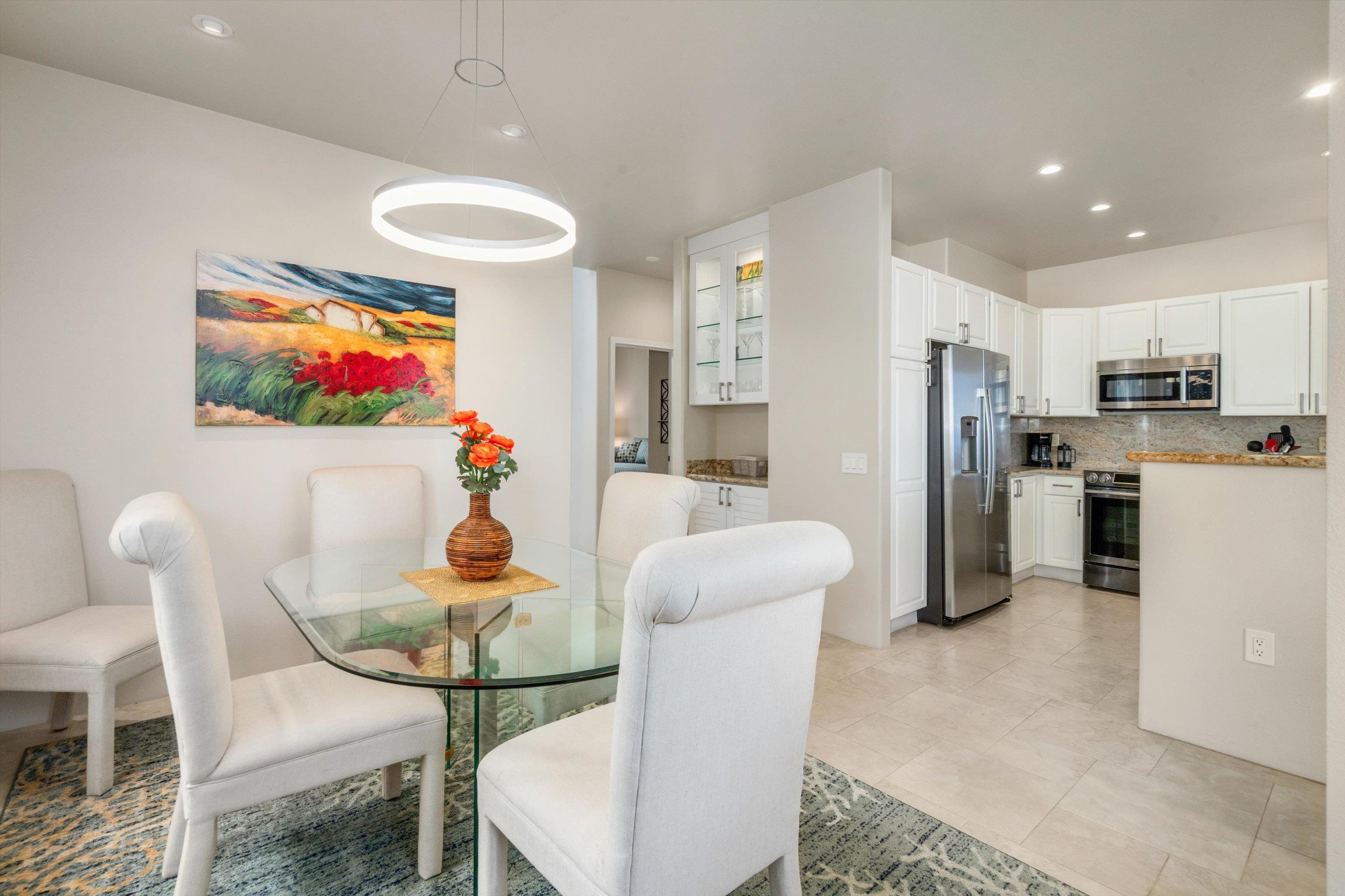 3950 Kalai Waa Street, Unit R 103 Kihei, HI 96753 - Photo 27 of 50 a living room with stainless steel appliances furniture a dining table and chairs
