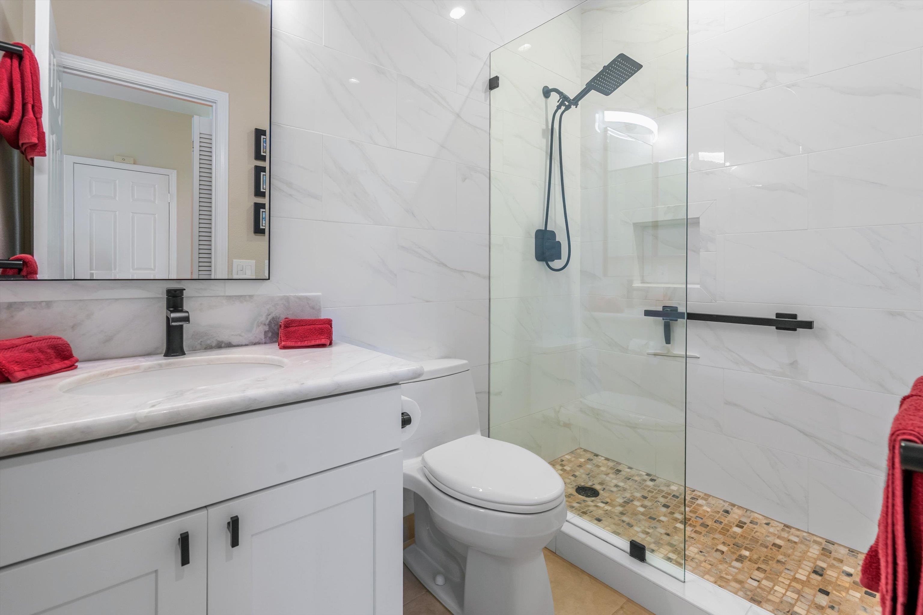 3950 Kalai Waa Street, Unit R 103 Kihei, HI 96753 - Photo 38 of 50 a bathroom with a sink toilet vanity and shower