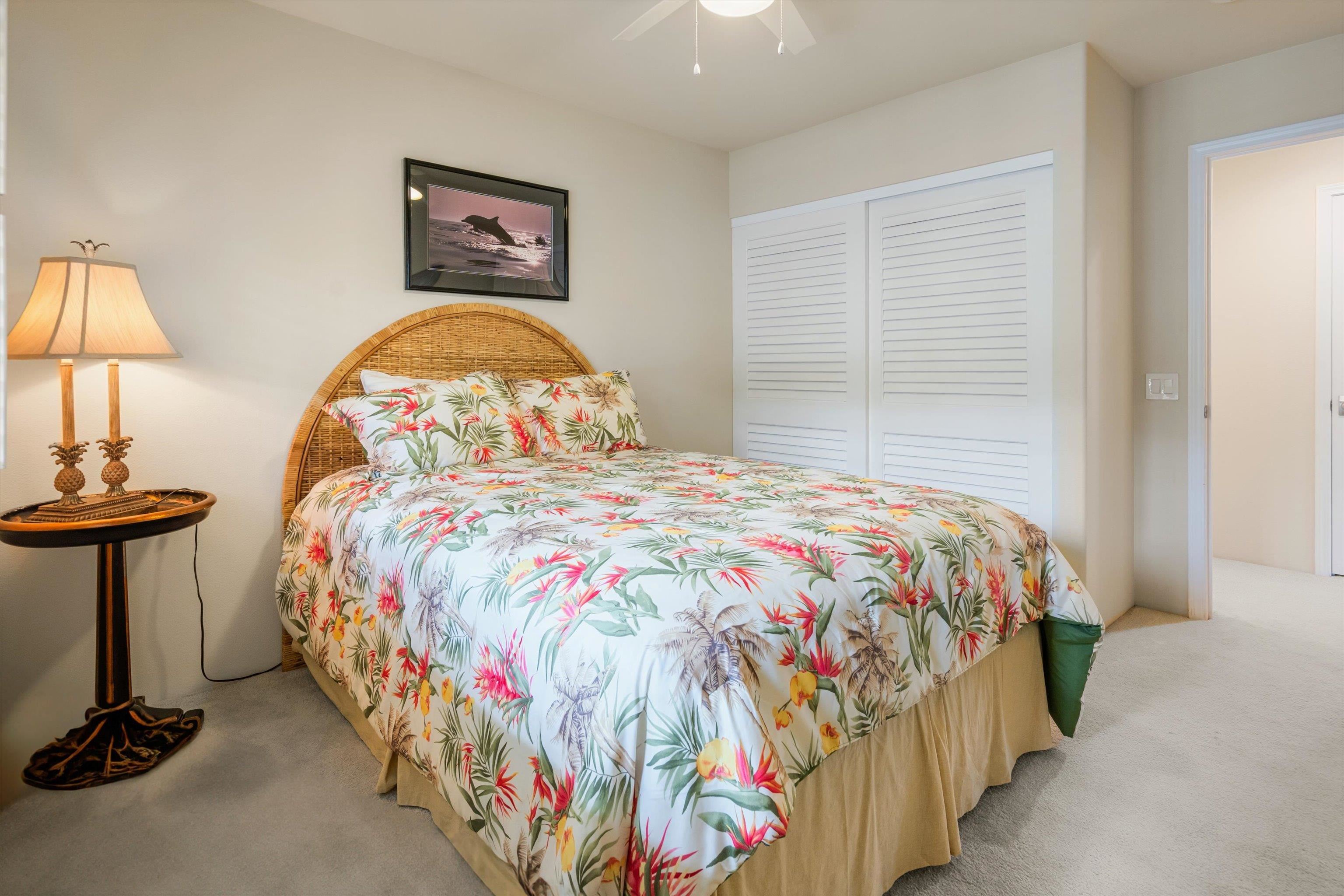 3950 Kalai Waa Street, Unit R 103 Kihei, HI 96753 - Photo 40 of 50 a bedroom with a bed and a lamp