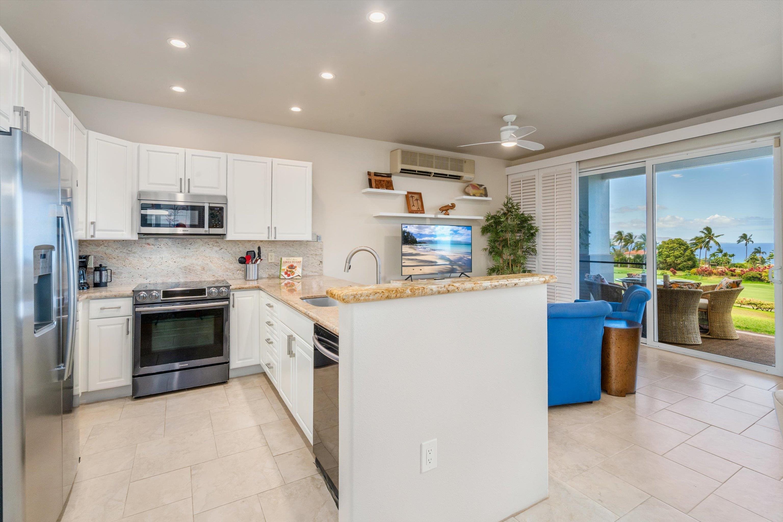 3950 Kalai Waa Street, Unit R 103 Kihei, HI 96753 - Photo 44 of 50 a kitchen with a stove top oven and refrigerator