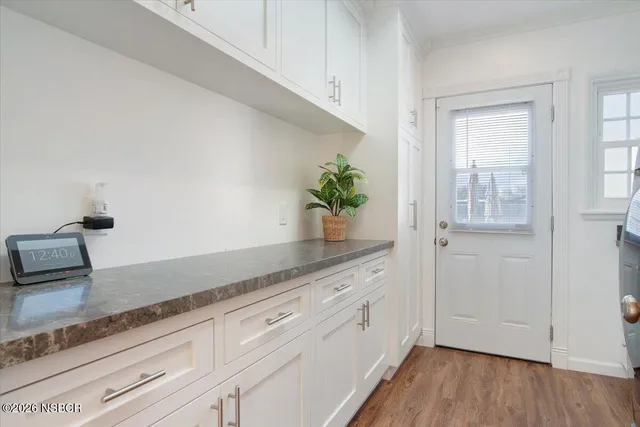 a kitchen with granite countertop a potted plant on the counter
