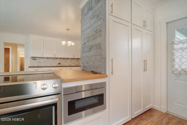 a stove top oven sitting inside of a kitchen