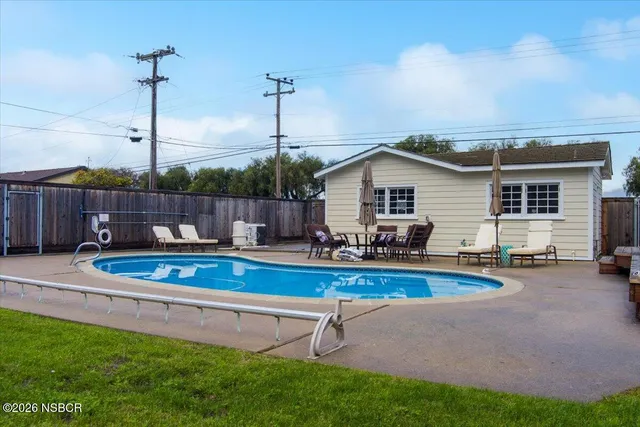 an aerial view of a house with a swimming pool