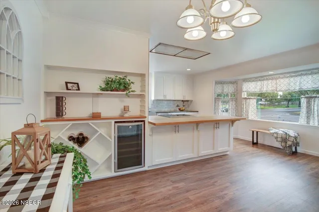 a kitchen with a refrigerator sink and cabinets