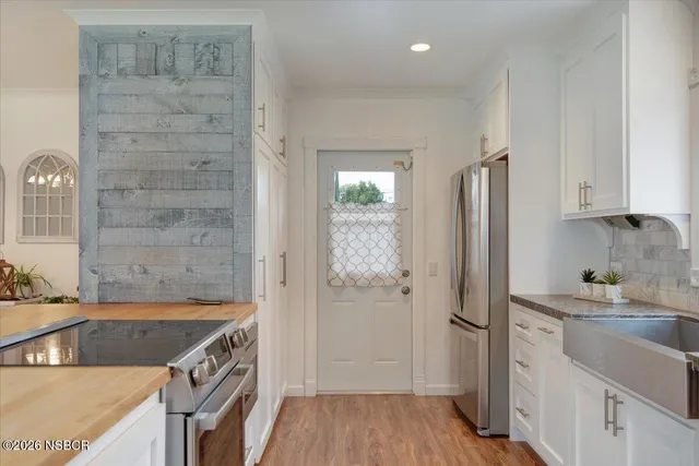 a kitchen with a refrigerator and a sink