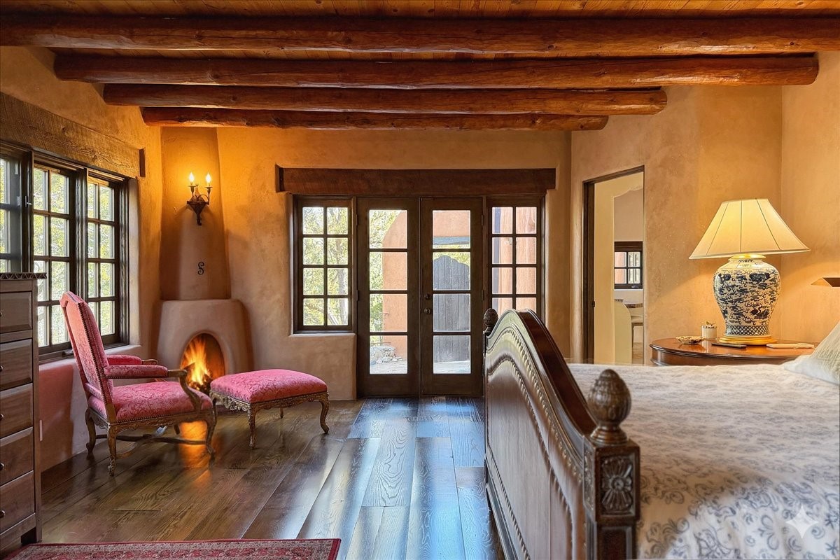 1433 Upper Canyon Road Santa Fe, NM 87501 - Photo 3 of 57 Owner's Suite With Two Corner Kiva Fireplaces