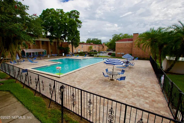 a park view with a seating space and a garden