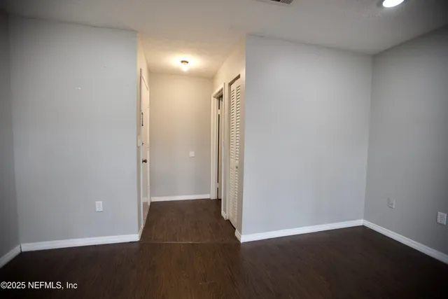 a view of a room with wooden floor