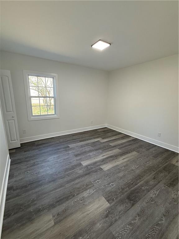 1418 East 10th Street West Point, GA 31833 - Photo 11 of 31 an empty room with wooden floor and windows