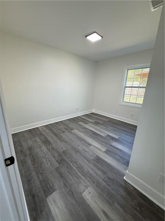 1418 East 10th Street West Point, GA 31833 - Photo 13 of 31 an empty room with wooden floor and windows