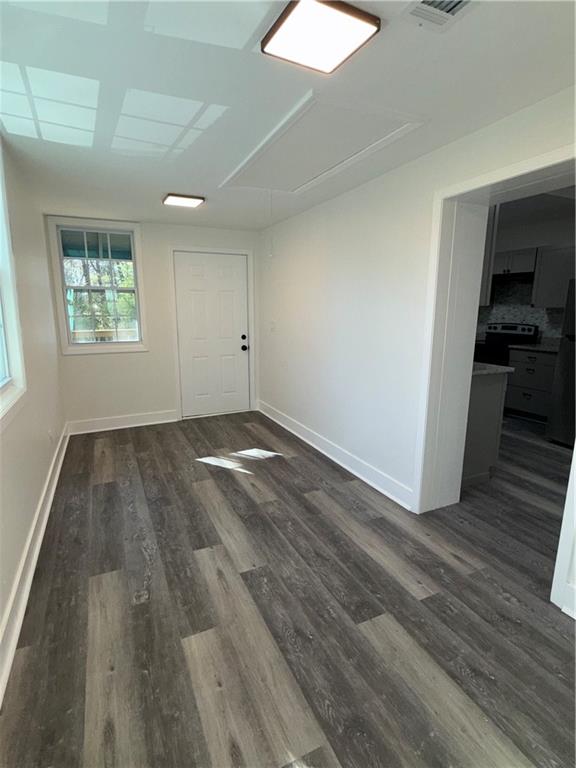 1418 East 10th Street West Point, GA 31833 - Photo 17 of 31 an empty room with wooden floor and windows