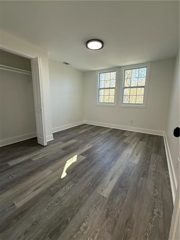 1418 East 10th Street West Point, GA 31833 - Photo 19 of 31 an empty room with wooden floor and windows