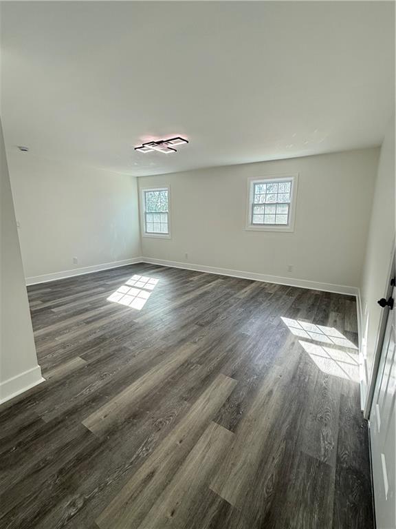 1418 East 10th Street West Point, GA 31833 - Photo 21 of 31 an empty room with wooden floor and windows