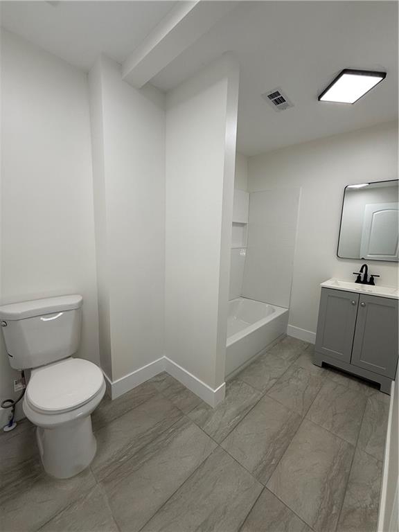 1418 East 10th Street West Point, GA 31833 - Photo 23 of 31 a bathroom with a toilet a sink and mirror