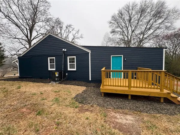 a view of a house with a wooden fence