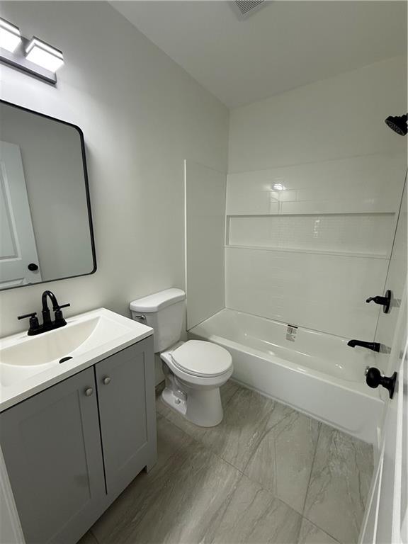 1418 East 10th Street West Point, GA 31833 - Photo 9 of 31 a bathroom with a toilet a sink a mirror and bathtub