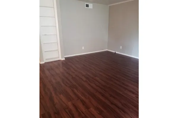 a view of a room with wooden floor and closet