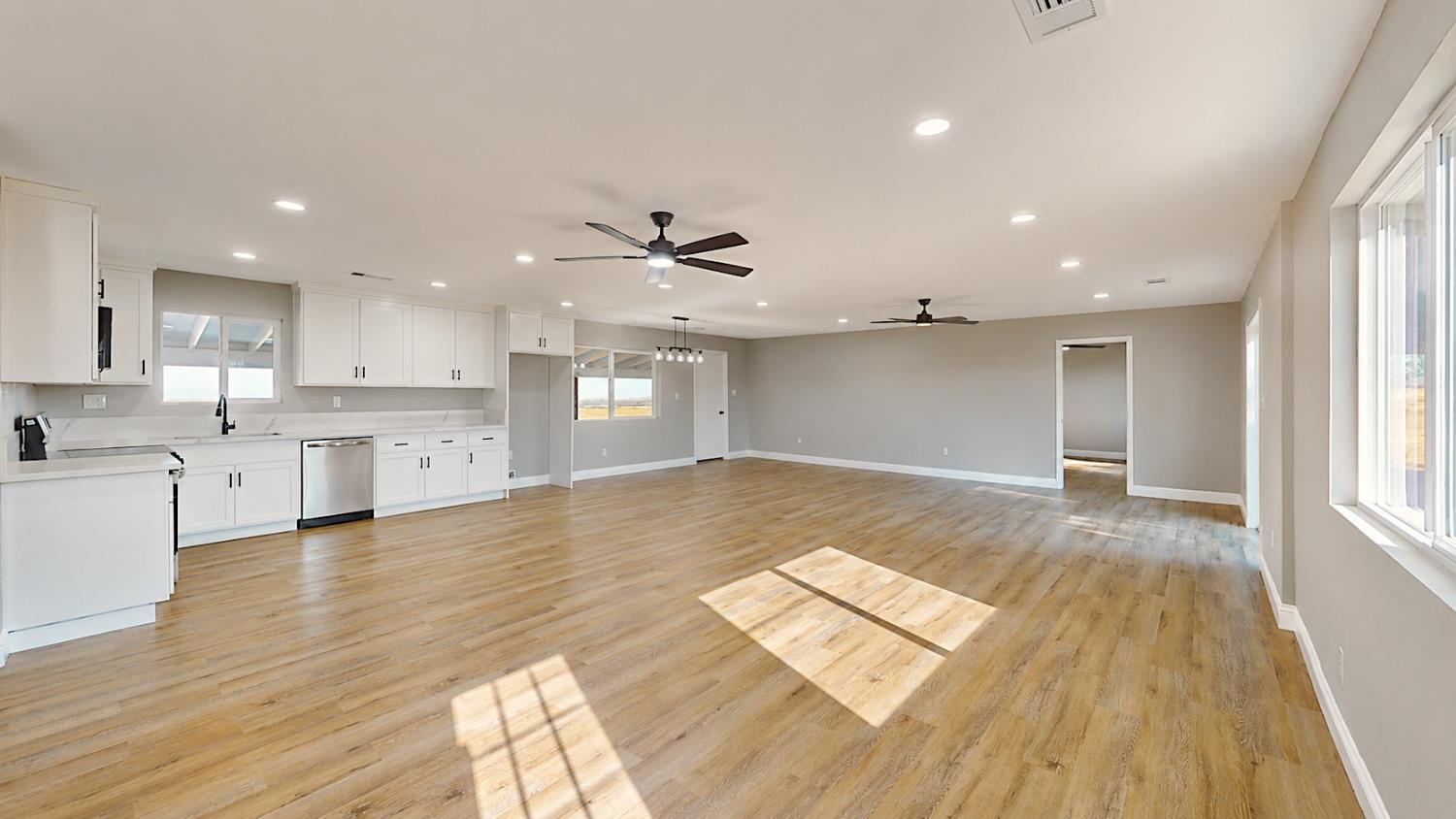 4728 Zorro Road La Grange, CA 95329 - Photo 13 of 56 Expansive open-concept living area featuring wood-finish flooring, recessed lighting, and ceiling fans.