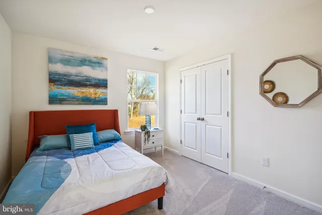 a bedroom with a bed and a painting on the wall