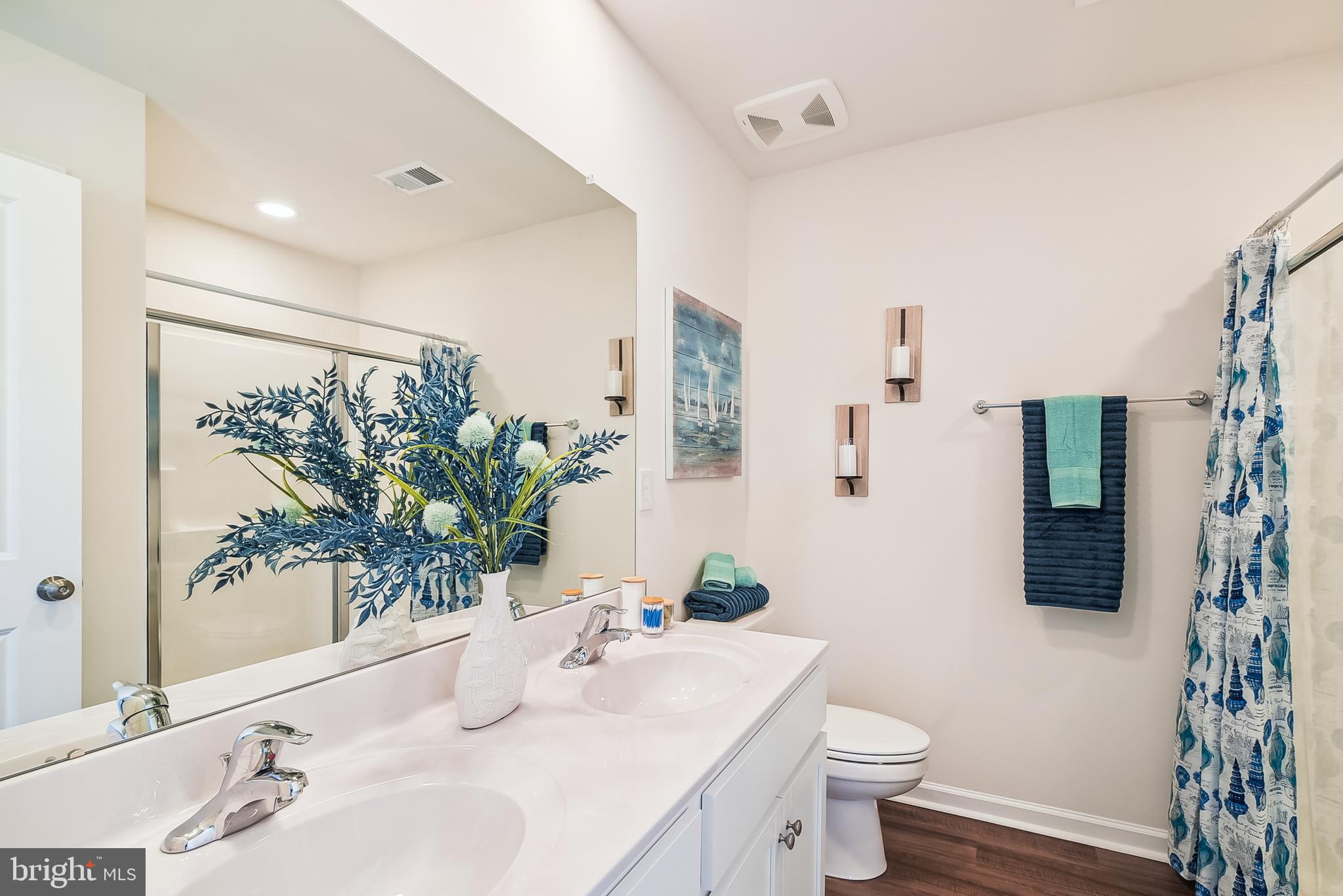 9716 Camp Road Laurel, DE 19956 - Photo 20 of 25 a bathroom with a sink a toilet and a large mirror