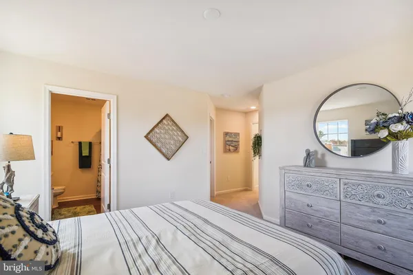 a bedroom with a large bed and a dresser