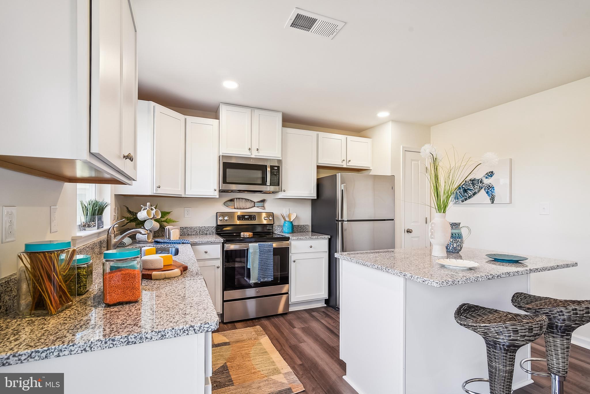 9716 Camp Road Laurel, DE 19956 - Photo 6 of 25 a kitchen with granite countertop a refrigerator stove microwave and sink